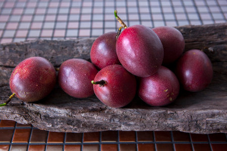 Ripe passion fruit in wooden tub on tabletop