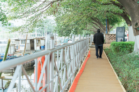 Man walking on the bridge over the river in the park, Thailand.の写真素材