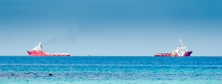 Two red cargo ship on the seaの写真素材