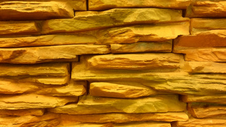 Background of yellow stone wall made with blocks.の写真素材