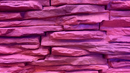 Background of pink stone wall made with blocks.の写真素材