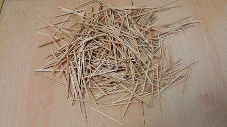 Bamboo wooden skewers isolated on wood floorの写真素材