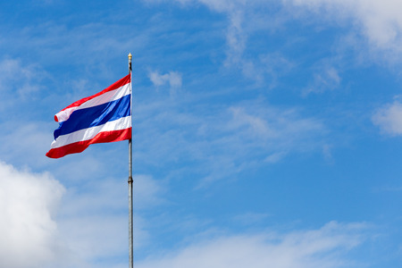 Image of waving Thai flag of Thailand with blue sky background.