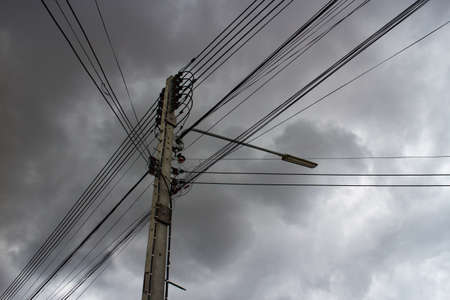 Electric poles amid the rain clouds forming