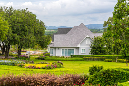 Luxury house in the garden with green grass and flowers.の写真素材