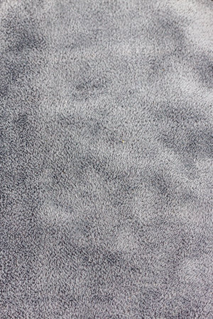 Close up detail of grey fabric texture background. Macro view of carpet material.