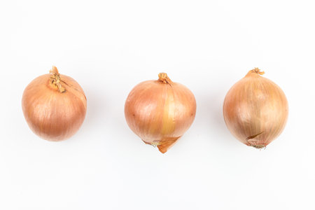Three onions isolated on white background, top view. Flat lay.の写真素材