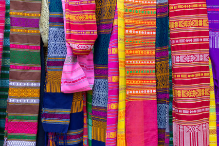 Colorful fabrics for sale at a market stall in Chiang Mai, Thailand.
