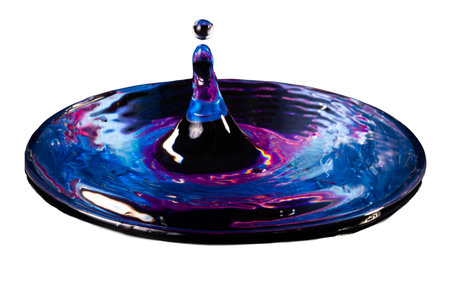 drop of water falling on a blue plate isolated on a white backgroundの写真素材