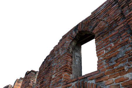 Historic brick architecture featuring windows and a stone wall on white backgroundの写真素材