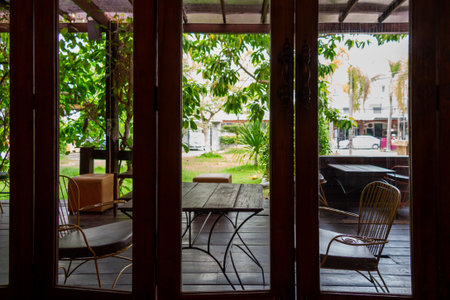 View from Cafe: A serene cafe captures a moment, with the wooden table and chairs drawing the...