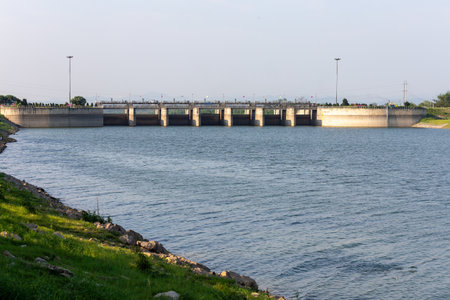 The summer landscape image shows a dike, boats on the water, and distant views.