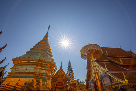 The gleaming golden architecture of the ancient pagoda at Wat Phra That Doi Suthep showcases...
