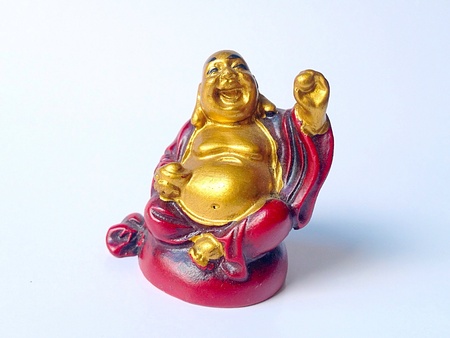 Statuette of laughing Buddha isolated on white .の素材