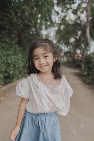Sweet little girl outdoors looking at camera
