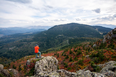 Hiker on the top of the mountain looking at the valley.の写真素材