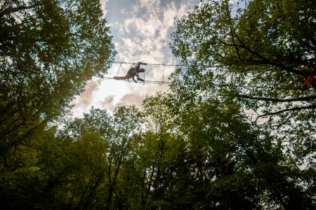 Ropejumping in the forest. The concept of extreme sports and healthy lifestyle.