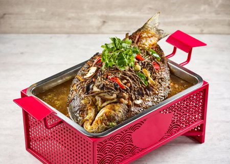 signature fish with Mushroom Herbs in a dish isolated on stew on mat side view on grey backgroundの写真素材