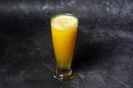 Mixed Fruit Juice of papaya, pineapple, and orange served in glass isolated on grey background top view of indian and bangladesh foodの写真素材