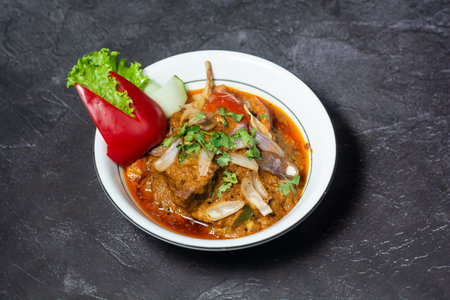 Spicy mutton karahi served in dish isolated on grey background top view of indian and bangladesh foodの写真素材