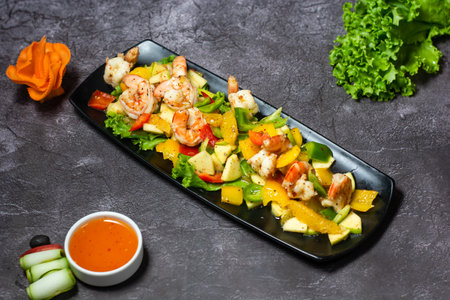 Shrimps salad with Orange, apple, cucumber, tomato and sauce served in dish isolated on grey background top view of indian and bangladesh foodの写真素材