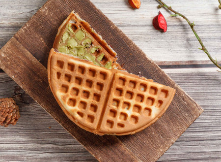 Red Bean Matcha waffle served on wooden board isolated on table top view of dessertの写真素材
