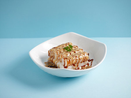 Hong-Kong Street Style Steamed Rice Rolls with Sweet and Peanut Sauce with chopsticks served in a dish isolated on mat side view on grey backgroundの写真素材