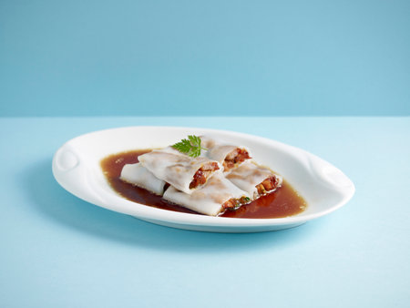 Steamed Rice Rolls with BBQ Pork Filling with chopsticks served in a dish isolated on mat side view...