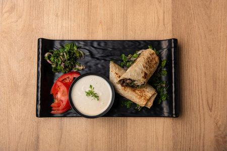 Arabic Shawarma with dip and salad served in dish isolated on table top view of arabian foodの写真素材