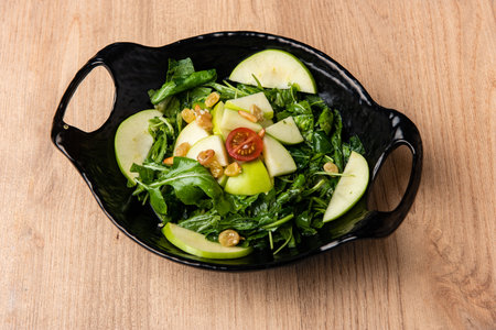 Fresh healthy Apple salad with green leaves served in dish isolated on table top view of arabian foodの写真素材