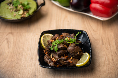 Chicken Liver masala with lemon slice served in dish isolated on table top view of arabian foodの写真素材