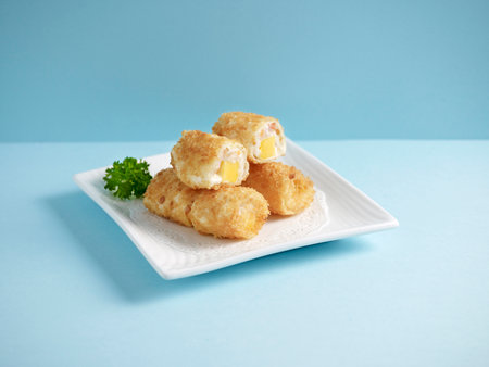 Crispy Prawn and Mango Fritter Served in a dish isolated on wooden board side view on grey backgroundの写真素材