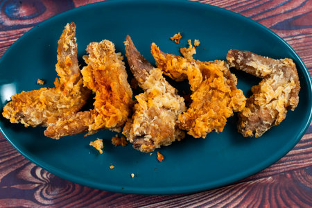 Crispy chicken wings with tomato sauce and mayo dip isolated on cutting board side view of fastfoodの写真素材