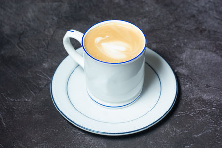 Hot Cappuccino served in coffee cup isolated on grey background top view of indian and bangladesh foodの写真素材