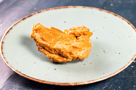 Crispy fried chicken piece in a plate isolated on marble background top view fast foodの写真素材