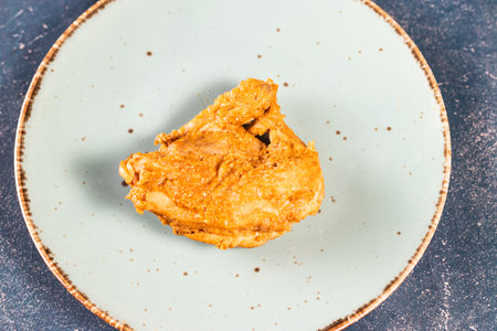 Crispy fried chicken piece in a plate isolated on marble background top view fast foodの写真素材