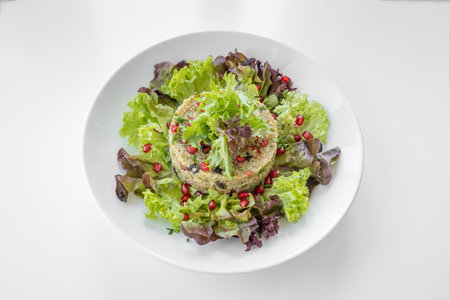 Asian Quinoa Salad with pomegranate seeds and leaves served in a dish isolated on grey background top viewの写真素材