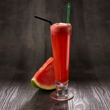 Watermelon Juice with straw served in glass isolated on table side view healthy morning drinkの写真素材