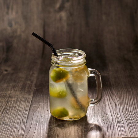 Lime Water with straw served in glass isolated on table side view healthy morning drinkの写真素材