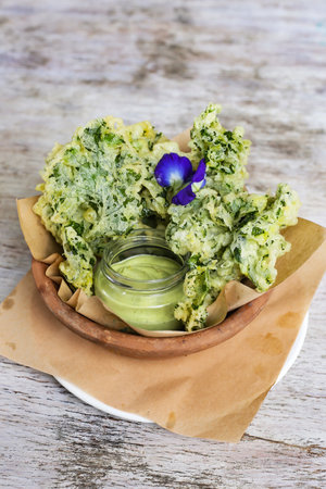 Kale Chips with Dip served in a dish isolated on grey background side view of snacksの写真素材