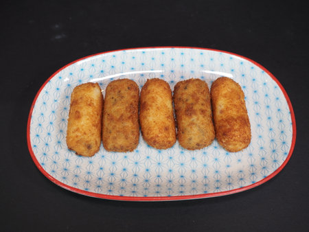 Ham and Mushroom Croquettes served in a dish isolated on dark background top viewの写真素材