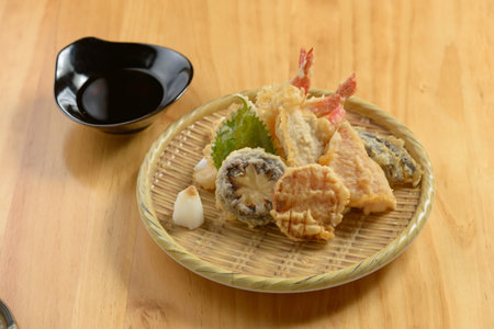 japanese food Tempura Moriawase in a wooden plate isolated on wooden table top viewの写真素材
