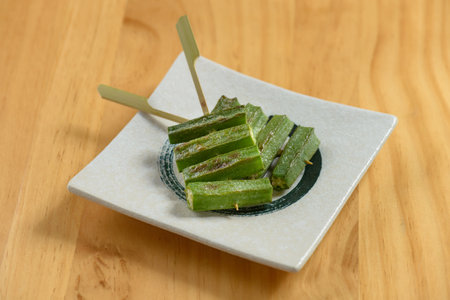 japanese food okra in a white tray isolated on wooden table top viewの写真素材