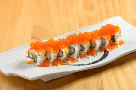 Japanese sushi food rainbow maki in a white tray isolated on wooden table top viewの写真素材