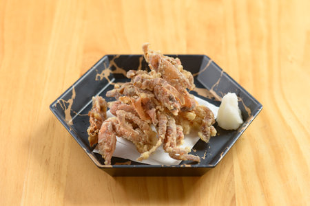 Crispy Deep-fried Kani Karaage in a black bowl on wooden background top view of japanese foodの写真素材