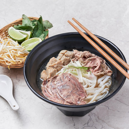 Beef Pho with noodle and lime served in a dish isolated on grey background side view of vietnam foodの写真素材
