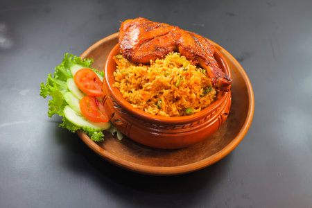 Chicken matka biryani with salad served in a matka isolated on dark background side view of indian spicy foodの写真素材