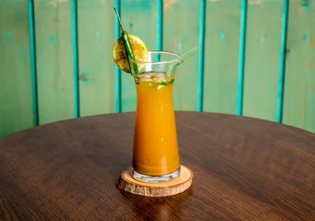 Cumin Water or jeera pani served in glass isolated on wooden table side view of summer drinkの写真素材