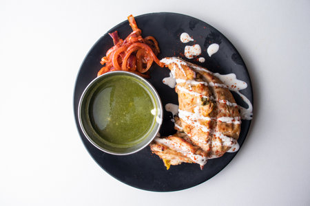 Arabian Tandoori chicken with chili sauce served in a dish isolated on grey background top view of bangladesh foodの写真素材