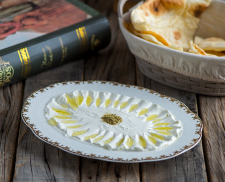 Labneh or labna served in a dish isolated on wooden background side view of appetizerの写真素材